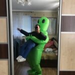 Green Alien Carrying Human Costume photo review